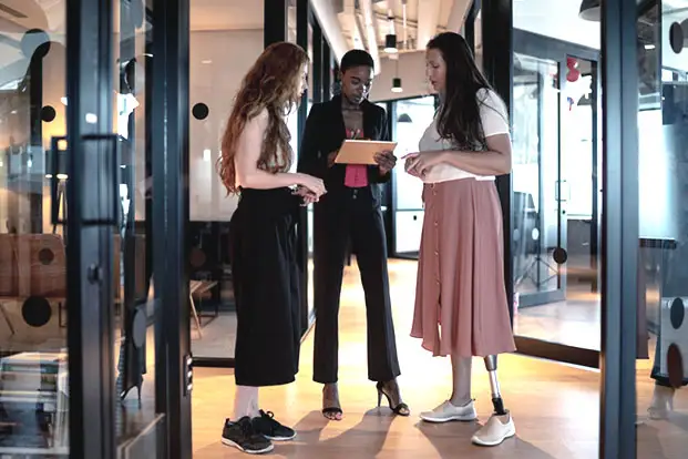 A group of people standing in front of a glass door