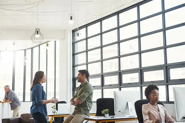 A group of people sitting around a conference room