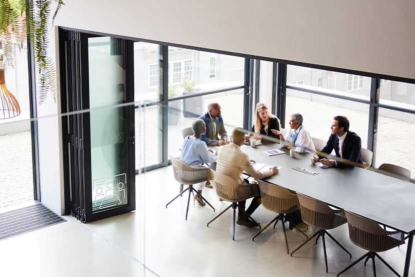 A group of people sitting around a table for a business meeting